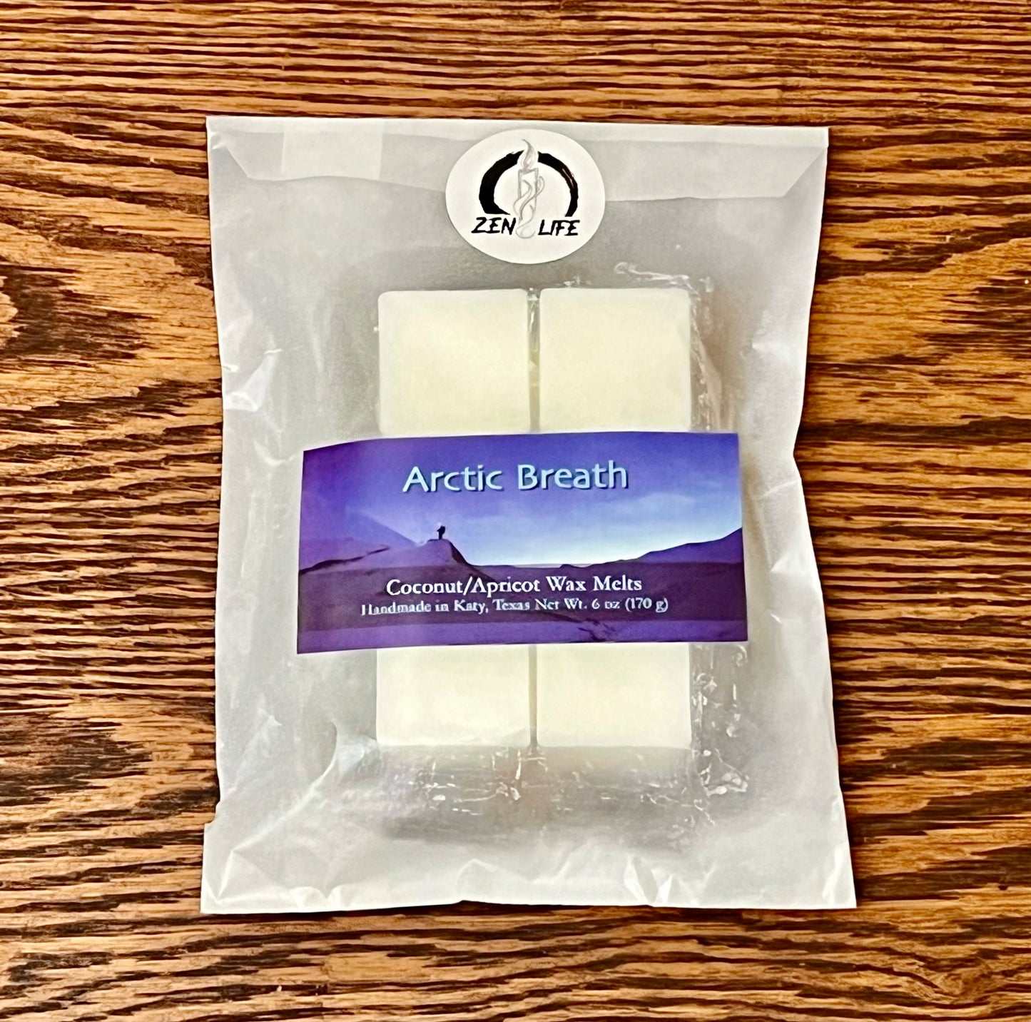 Wax melts for the Arctic Breath scent on a wooden surface. Each bag contains six 1 oz melts.