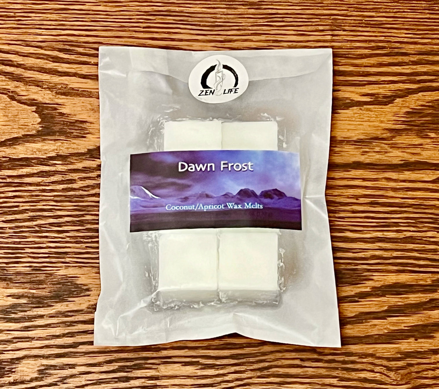 Wax melts for the Dawn Front scent on a wooden surface. Each bag contains six 1 oz melts.